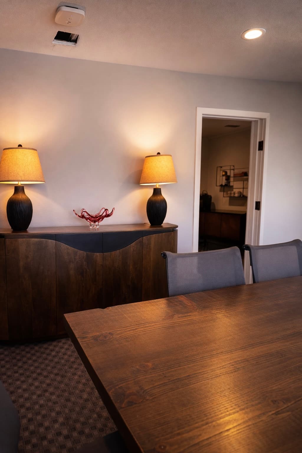 A boardroom for a Seattle law practice — plank wood, lamplight, and quiet authority.